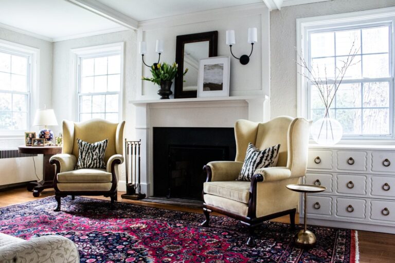 Living room renovation with a painted fireplace, wingback chairs and built in storage in Winchester, VA