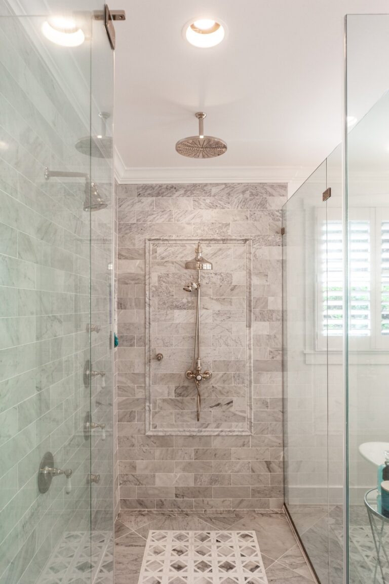 Tiled shower with a rain head, glass enclosure and patterned mosaic floor, bathroom remodeling in Winchester, VA